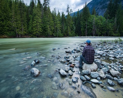 man relaxing looking at nature landscape